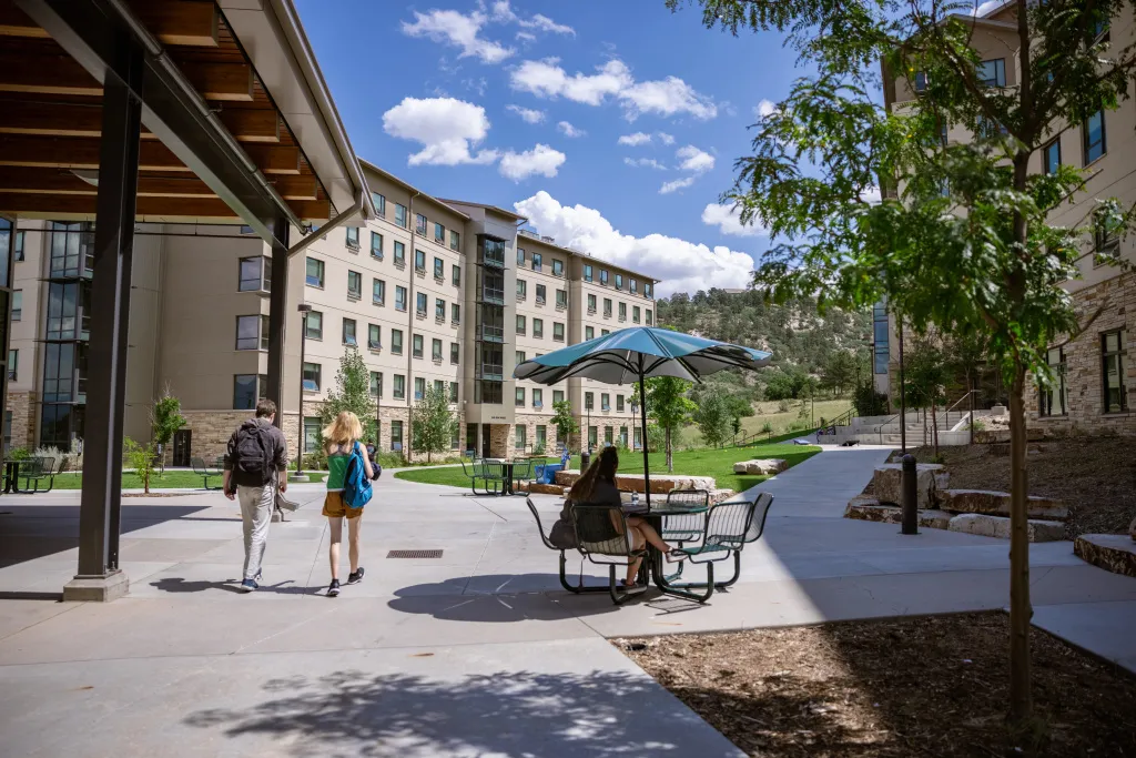 students sitting outside the roaring fork dining hall on UCCS' campus